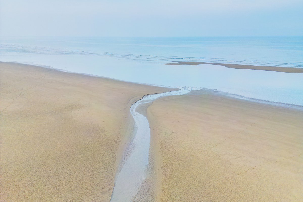 Paines Creek Beach Brewster Massachusetts tidal creek winding through marsh at sunset