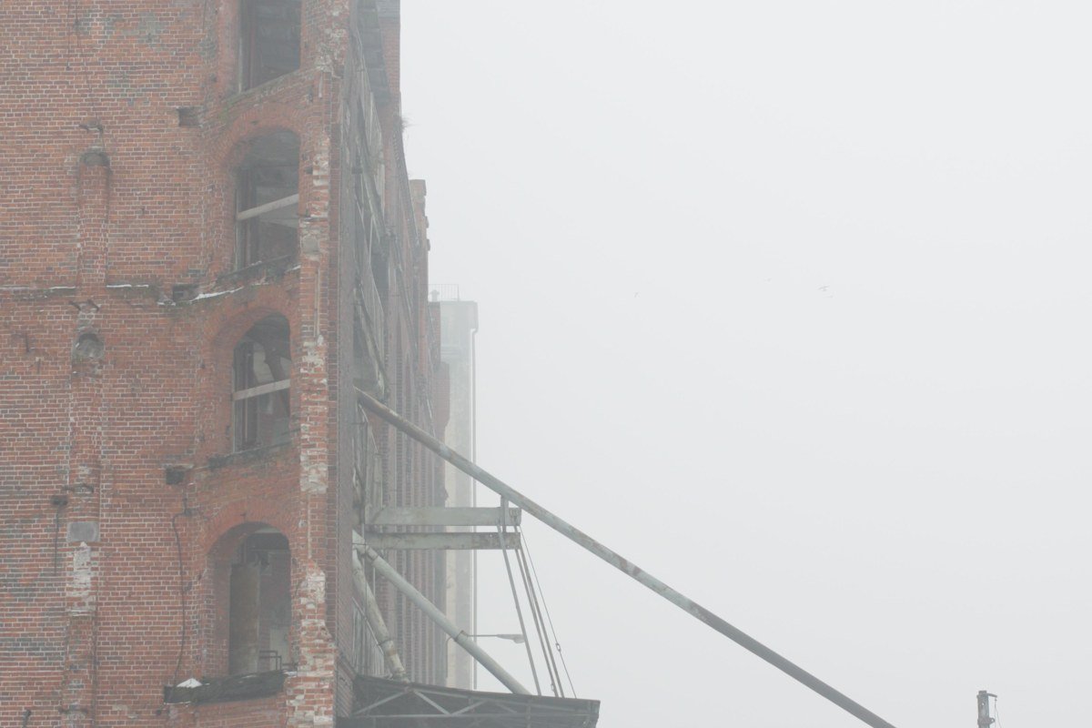 Belfast Maine waterfront fog settling over historic brick buildings