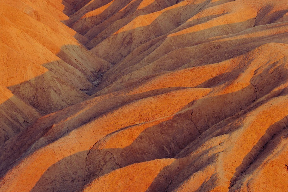 Mesquite Flat Sand Dunes at dawn with rippled sand shadows and Death Valley mountains behind