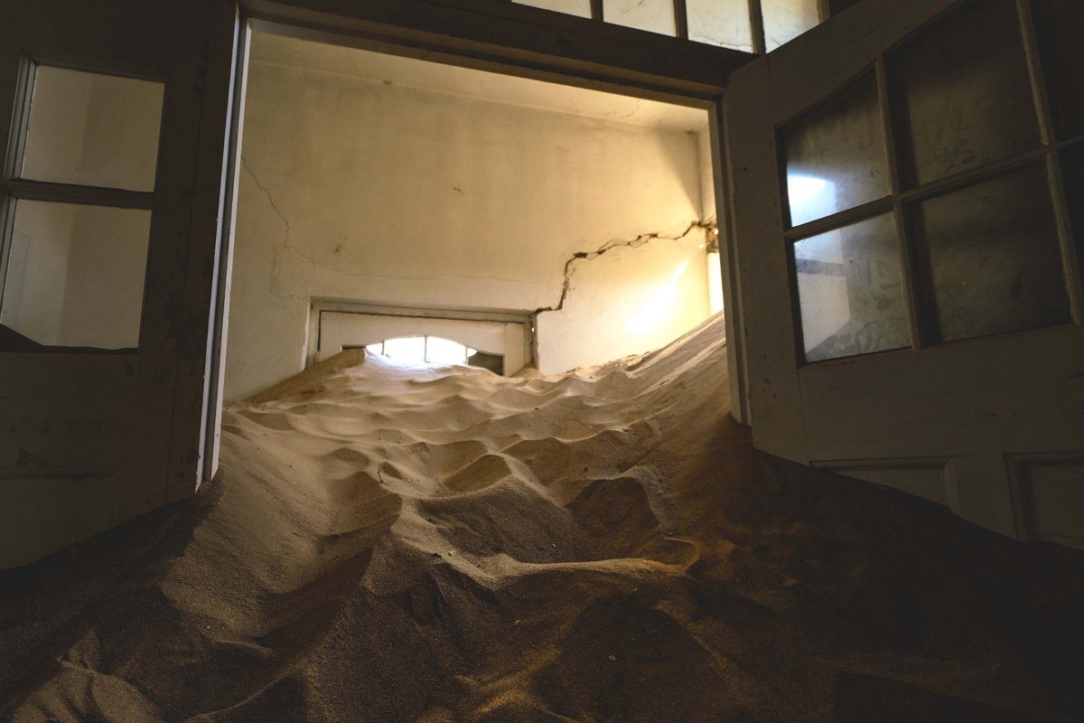 Rhyolite Ghost Town ruins in Nevada with crumbling bank building facade against desert sky