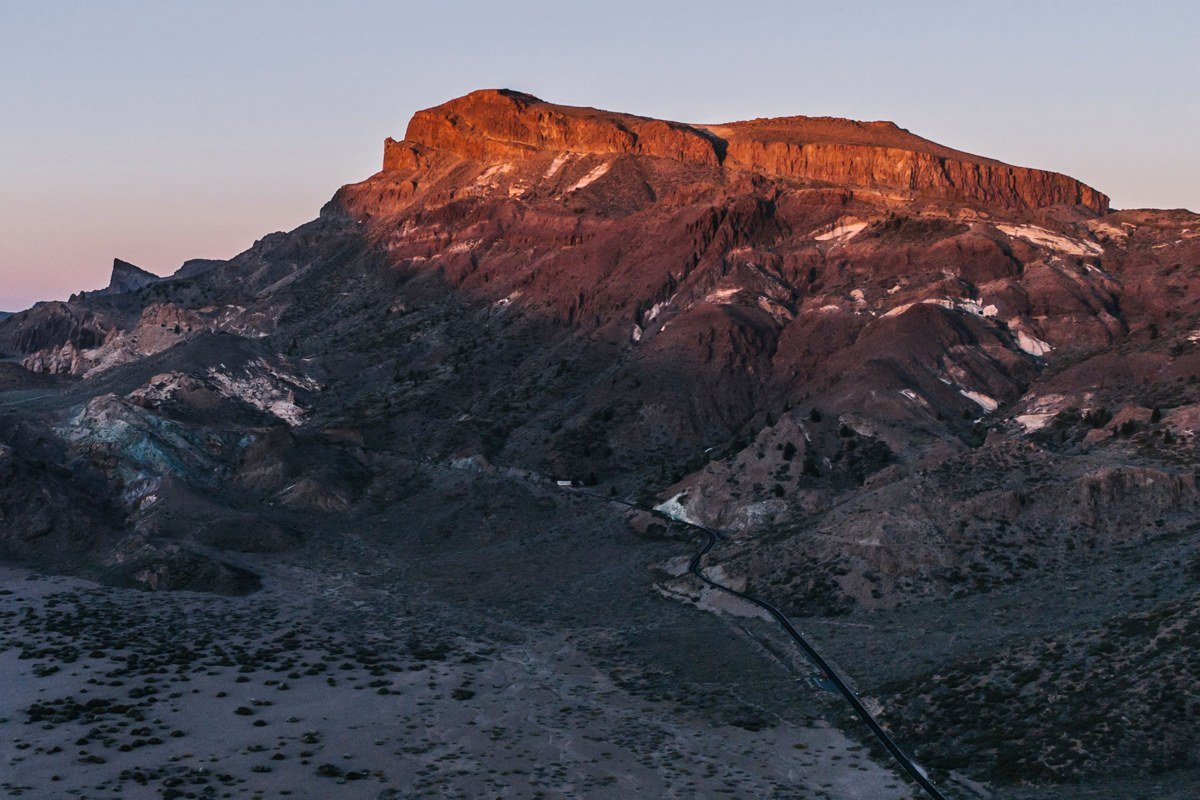 wide aerial view of Scenic Byway 12 winding through red rock hogbacks in southern Utah at sunset