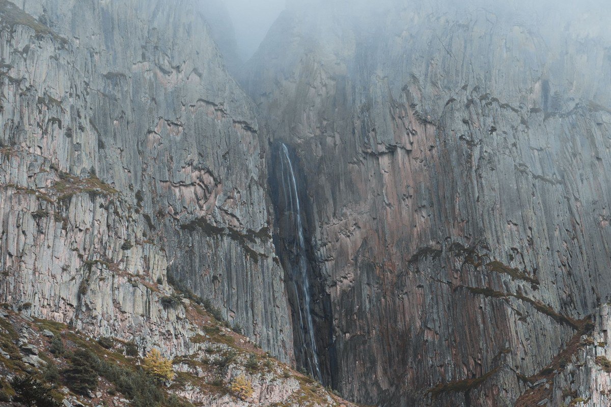 Hector Falls overlook with waterfall mist mixing with lake fog in autumn