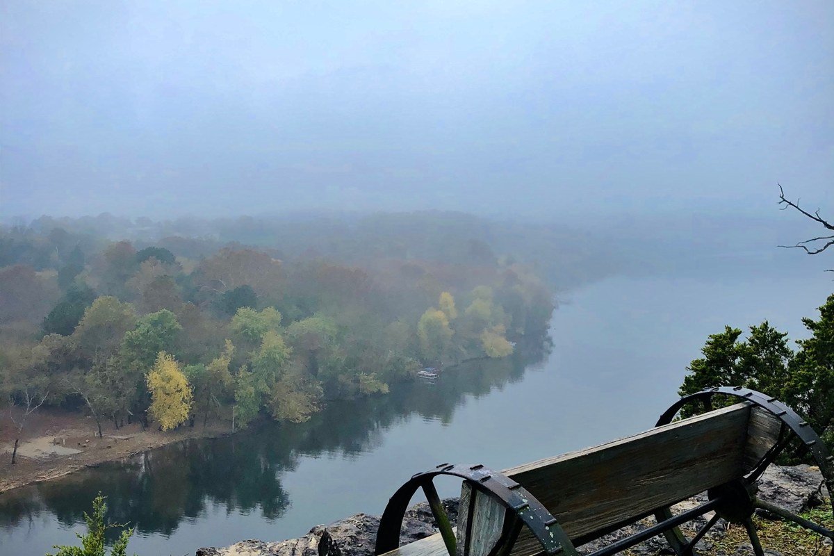 Honeoye Lake overlook with bare trees fog and still water in late autumn