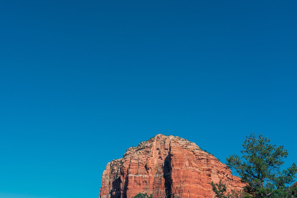 Bell Rock glowing pink at dawn, shot from the Bell Rock Pathway pullout