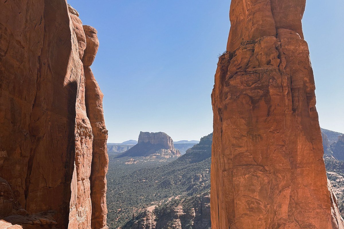 Devils Bridge Sedona Arizona natural sandstone arch with hikers crossing at sunrise