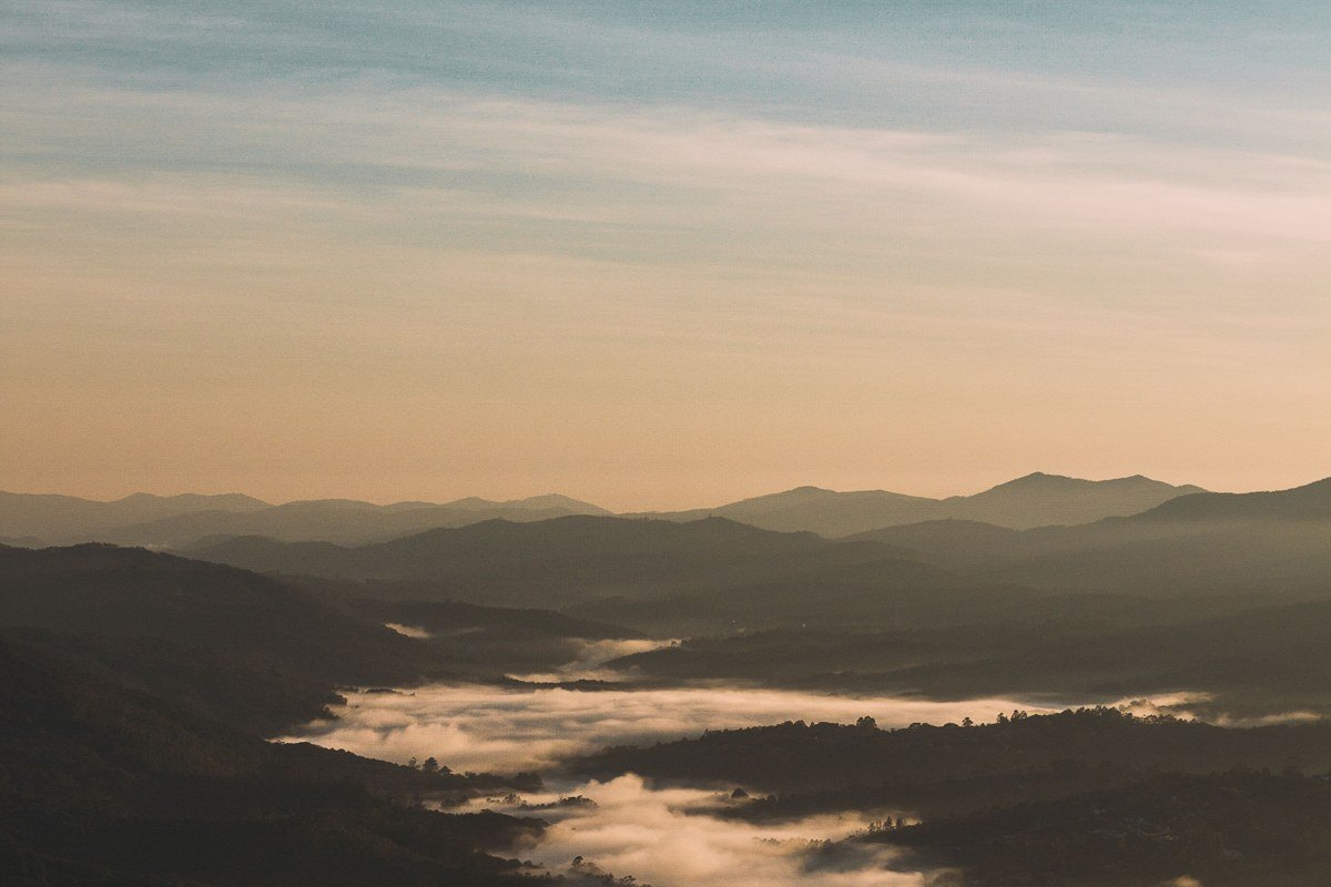 golden fall light spreading across the valley fog at Newfound Gap