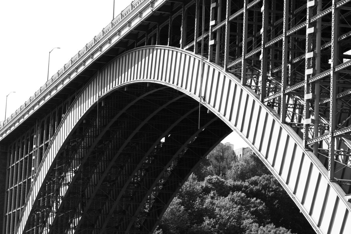 wide shot of the New River Gorge Bridge over whitewater rapids in West Virginia at golden hour