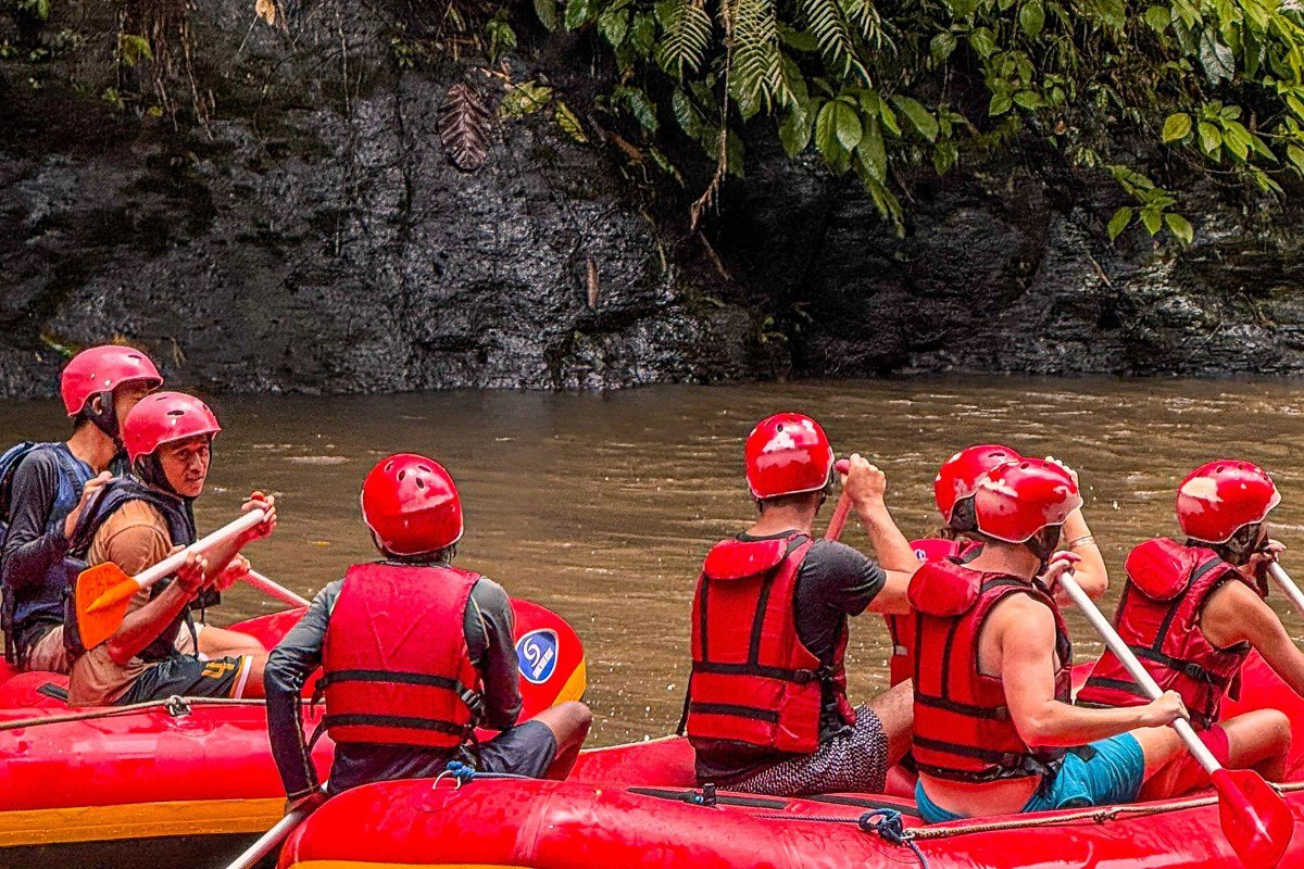 raft full of paddlers crashing through a rapid on the Lower New River Gorge West Virginia