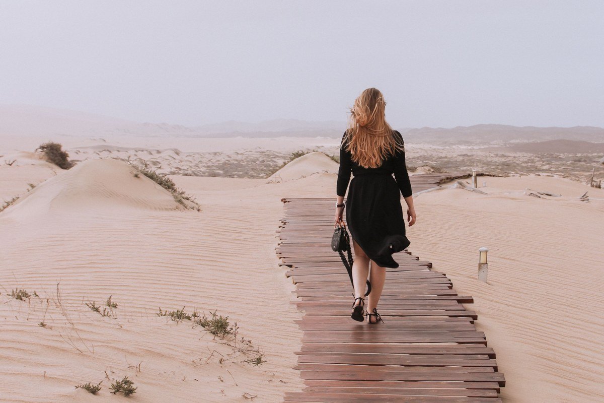 White Sands Interdune Boardwalk at dusk with wooden walkway curving into pale dunes